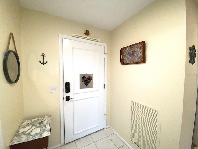 entryway with light tile patterned flooring