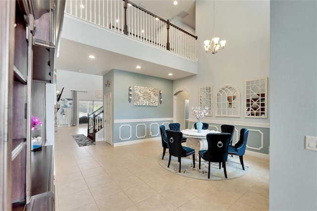 19300 Lonesome Pine Dr, Land O Lakes, FL 34638 - dining area with arched walkways, tile patterned floors, an inviting chandelier, a high ceiling, and recessed lighting