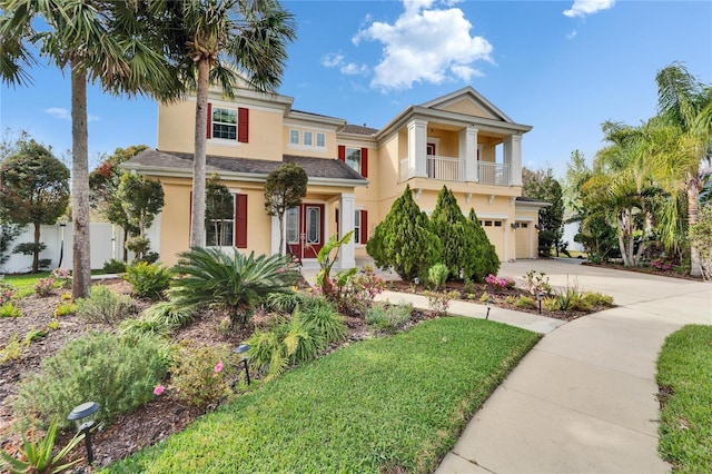 19300 Lonesome Pine Dr, Land O Lakes, FL 34638 - view of front facade featuring a balcony, a garage, fence, driveway, and stucco siding