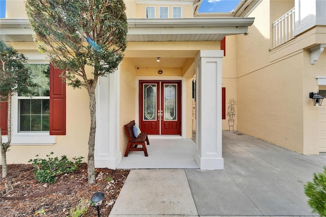 19300 Lonesome Pine Dr, Land O Lakes, FL 34638 - view of exterior entry featuring stucco siding and french doors