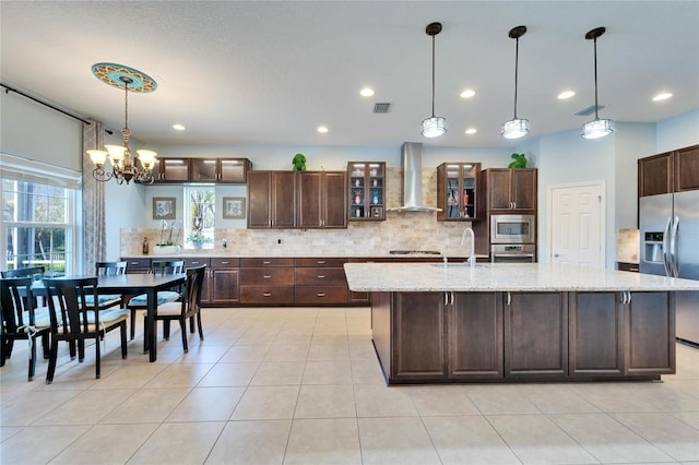 19300 Lonesome Pine Dr, Land O Lakes, FL 34638 - kitchen with wall chimney range hood, visible vents, stainless steel appliances, and decorative backsplash