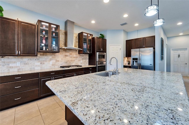 19300 Lonesome Pine Dr, Land O Lakes, FL 34638 - kitchen with visible vents, decorative backsplash, wall chimney exhaust hood, stainless steel appliances, and a sink