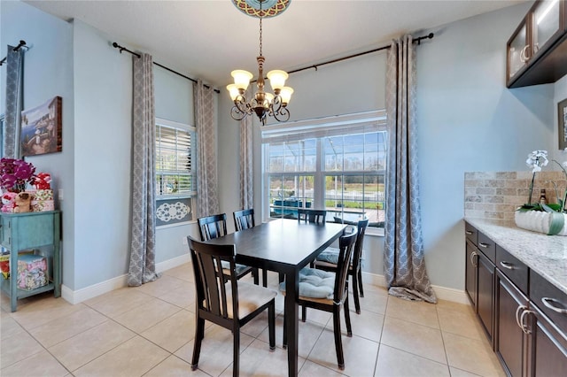 19300 Lonesome Pine Dr, Land O Lakes, FL 34638 - dining room with baseboards, a chandelier, and light tile patterned flooring