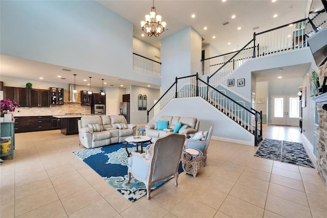 19300 Lonesome Pine Dr, Land O Lakes, FL 34638 - living area featuring light tile patterned floors, baseboards, a towering ceiling, an inviting chandelier, and stairs