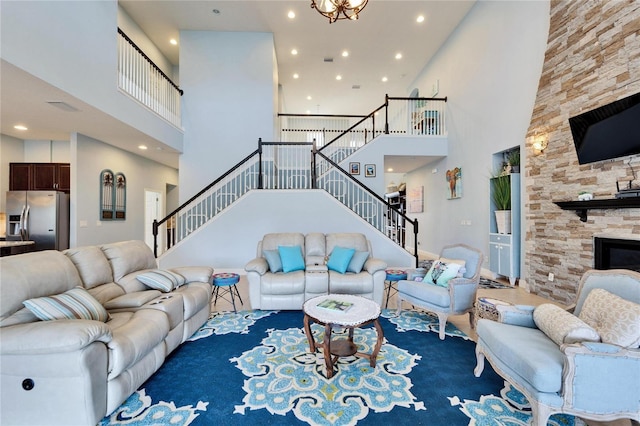 19300 Lonesome Pine Dr, Land O Lakes, FL 34638 - living area with recessed lighting, a high ceiling, stairway, and a stone fireplace