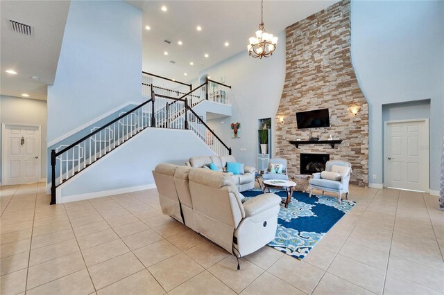 19300 Lonesome Pine Dr, Land O Lakes, FL 34638 - living room featuring visible vents, stairway, tile patterned flooring, a fireplace, and a notable chandelier