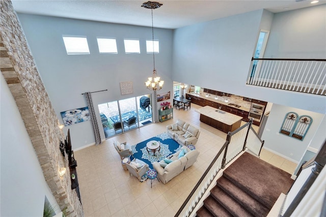 19300 Lonesome Pine Dr, Land O Lakes, FL 34638 - tiled living area featuring baseboards, stairway, a high ceiling, and an inviting chandelier