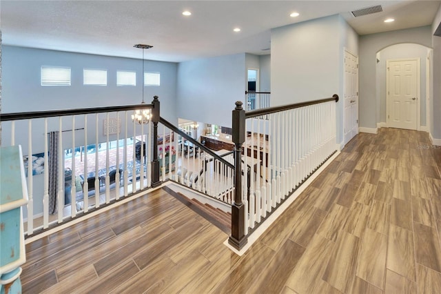 19300 Lonesome Pine Dr, Land O Lakes, FL 34638 - hallway with recessed lighting, visible vents, an inviting chandelier, wood finished floors, and baseboards