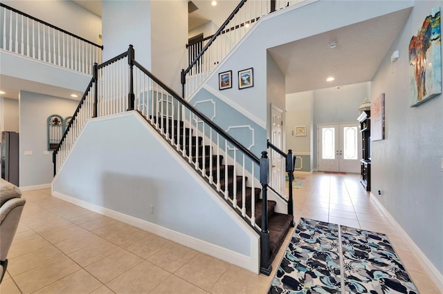 19300 Lonesome Pine Dr, Land O Lakes, FL 34638 - stairs with french doors, recessed lighting, a high ceiling, tile patterned flooring, and baseboards