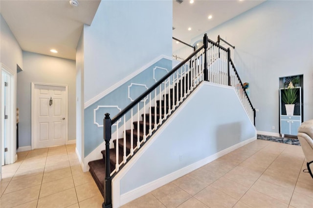 19300 Lonesome Pine Dr, Land O Lakes, FL 34638 - stairs with a high ceiling, recessed lighting, tile patterned flooring, and baseboards