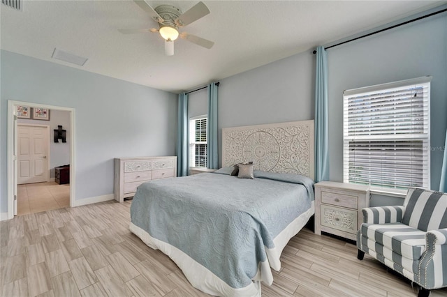 19300 Lonesome Pine Dr, Land O Lakes, FL 34638 - bedroom with baseboards, visible vents, a ceiling fan, and wood tiled floor