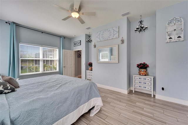 19300 Lonesome Pine Dr, Land O Lakes, FL 34638 - bedroom featuring visible vents, a ceiling fan, a textured ceiling, light wood-type flooring, and baseboards