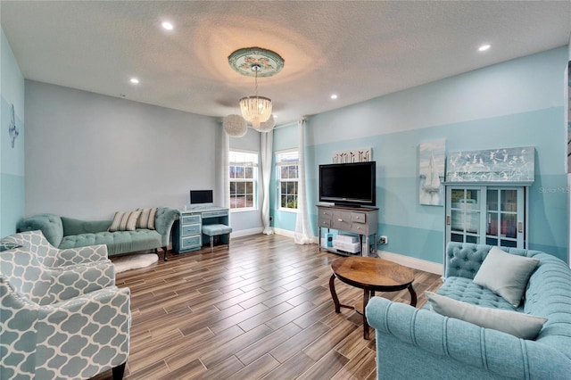 19300 Lonesome Pine Dr, Land O Lakes, FL 34638 - living room with a textured ceiling, baseboards, and wood finished floors