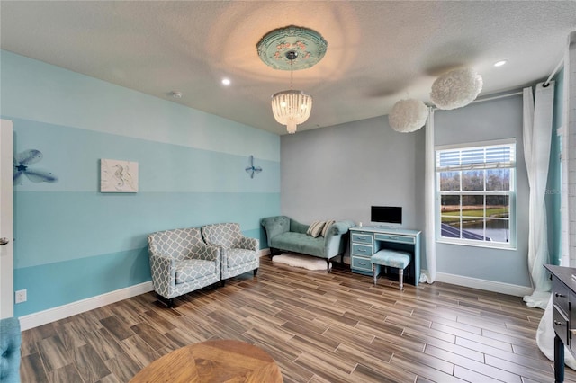 19300 Lonesome Pine Dr, Land O Lakes, FL 34638 - sitting room with baseboards, a textured ceiling, wood finished floors, and a notable chandelier