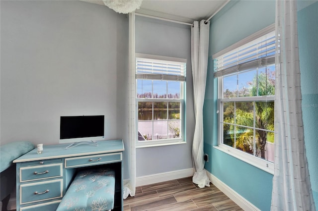 19300 Lonesome Pine Dr, Land O Lakes, FL 34638 - home office with baseboards, wood finish floors, and a healthy amount of sunlight