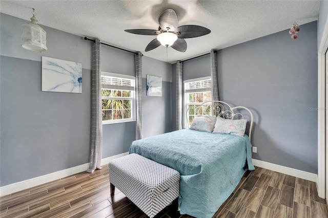 19300 Lonesome Pine Dr, Land O Lakes, FL 34638 - bedroom with wood finish floors, a ceiling fan, and baseboards