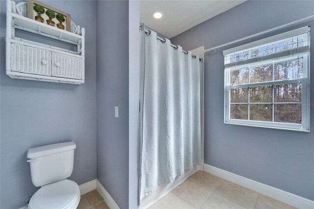 19300 Lonesome Pine Dr, Land O Lakes, FL 34638 - full bath featuring baseboards, a shower with shower curtain, toilet, and tile patterned floors