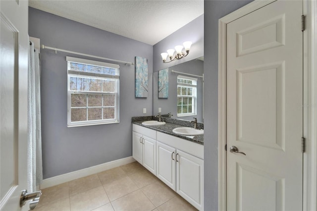 19300 Lonesome Pine Dr, Land O Lakes, FL 34638 - bathroom featuring tile patterned flooring, a textured ceiling, baseboards, and a sink