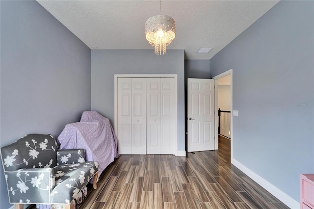 19300 Lonesome Pine Dr, Land O Lakes, FL 34638 - bedroom featuring a chandelier, a closet, wood finished floors, and baseboards