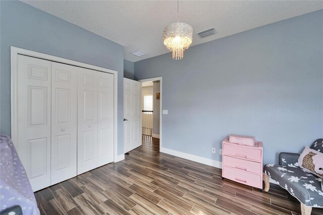 19300 Lonesome Pine Dr, Land O Lakes, FL 34638 - sitting room with wood finish floors, visible vents, a textured ceiling, a chandelier, and baseboards