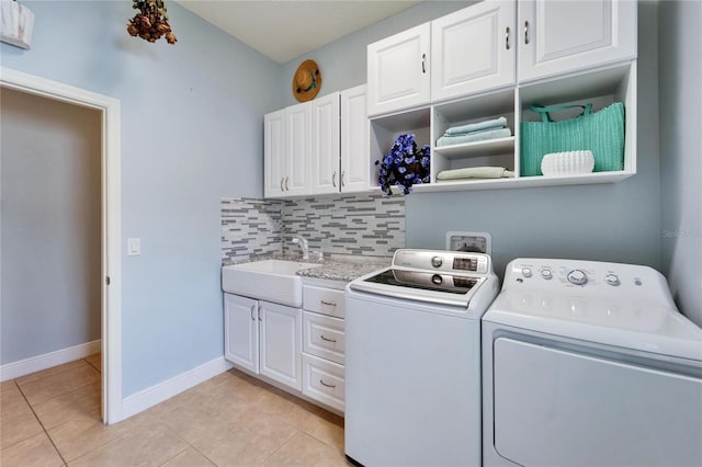 19300 Lonesome Pine Dr, Land O Lakes, FL 34638 - washroom featuring light tile patterned floors, washing machine and dryer, cabinet space, and a sink