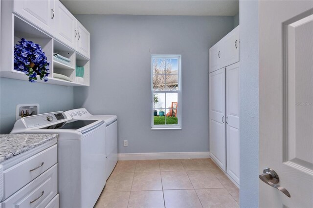 19300 Lonesome Pine Dr, Land O Lakes, FL 34638 - washroom featuring cabinet space, light tile patterned floors, baseboards, and washer and dryer