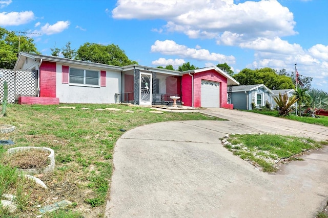 ranch-style home featuring a garage and a front lawn