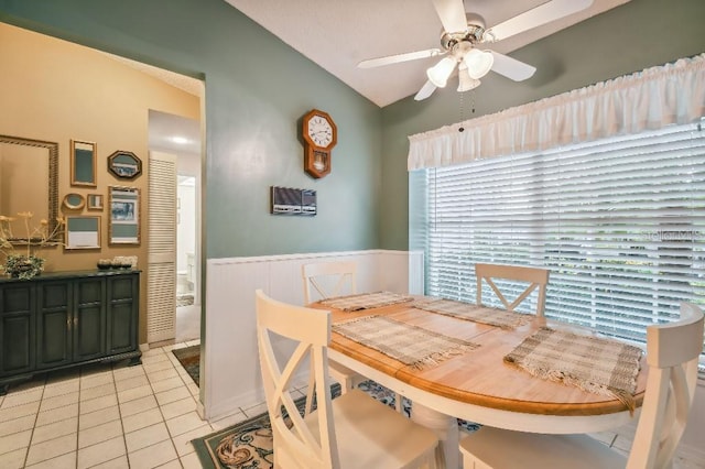 dining area featuring light tile patterned flooring, a healthy amount of sunlight, ceiling fan, and vaulted ceiling