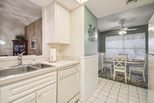 kitchen featuring white cabinets, sink, light tile patterned floors, dishwasher, and ceiling fan