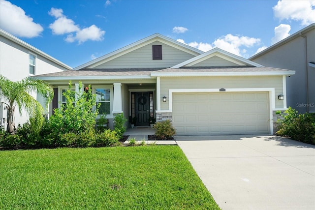 view of front of home featuring a garage and a front lawn