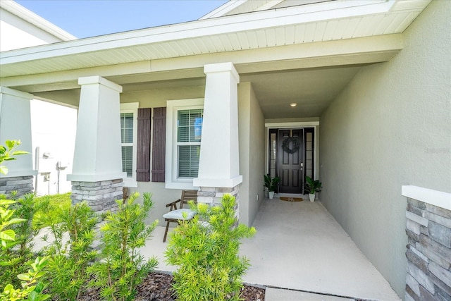 view of exterior entry featuring a porch