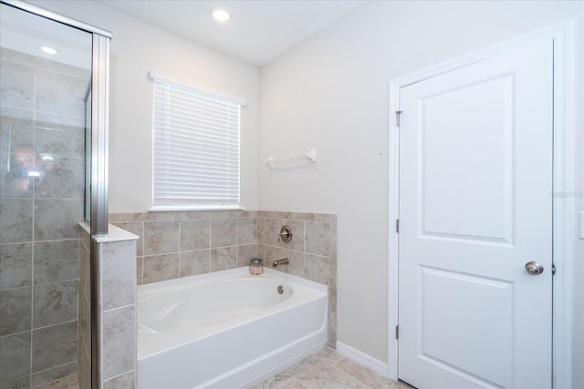 bathroom featuring tile patterned flooring and separate shower and tub