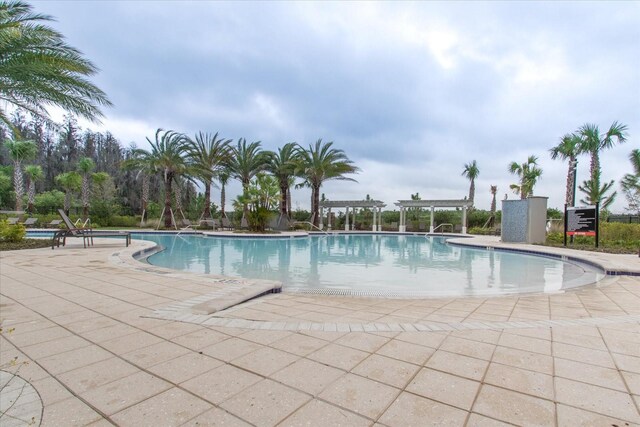 view of swimming pool featuring a patio area