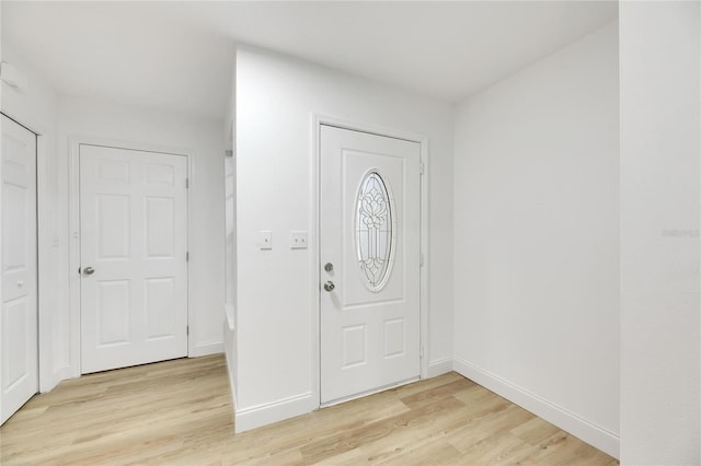 foyer entrance with light wood-type flooring