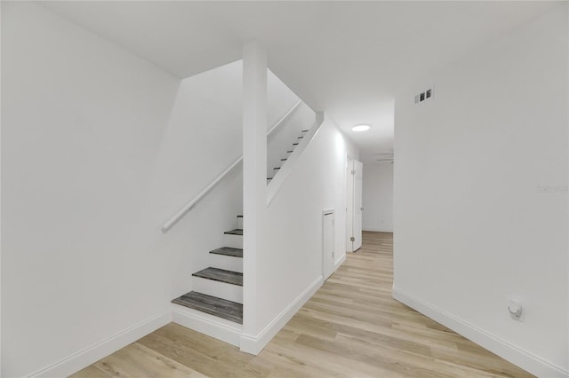 stairway featuring hardwood / wood-style floors