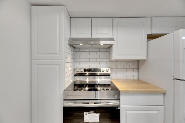 kitchen featuring stainless steel electric range, white cabinetry, white fridge, and range hood