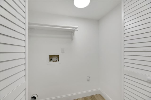 washroom with hookup for a washing machine, light hardwood / wood-style floors, and hookup for an electric dryer