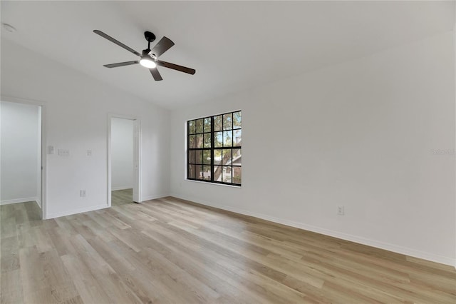 spare room with ceiling fan, lofted ceiling, and light wood-type flooring