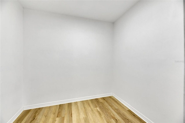 unfurnished room featuring light wood finished floors and baseboards