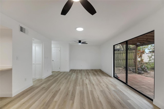 unfurnished room featuring light wood finished floors, baseboards, and visible vents