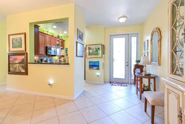 foyer entrance with light tile patterned floors