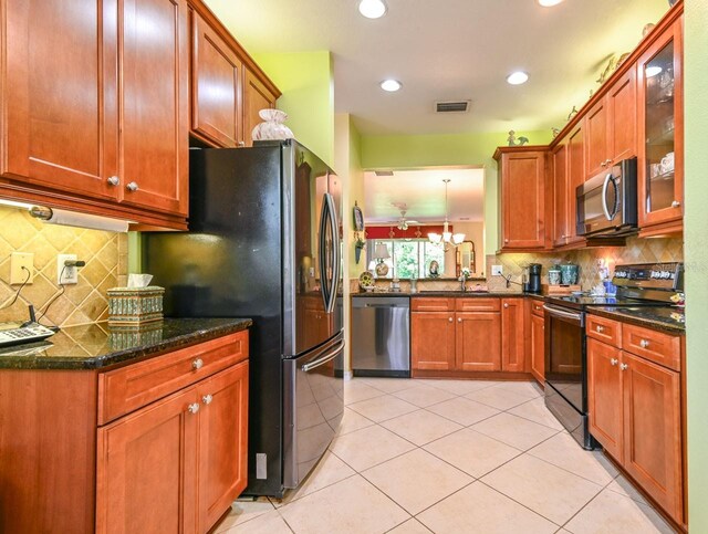 kitchen featuring decorative backsplash, pendant lighting, appliances with stainless steel finishes, and light tile patterned floors