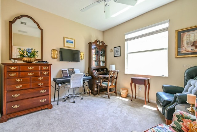 carpeted home office with ceiling fan