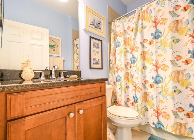 bathroom featuring tile patterned floors, vanity, and toilet