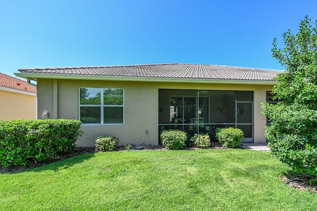 rear view of property with a lawn