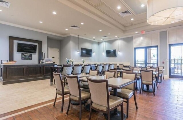 dining room featuring crown molding and hardwood / wood-style floors