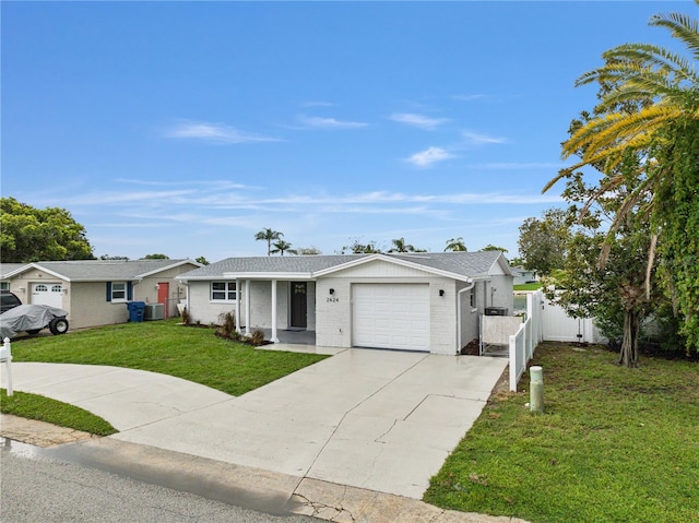 single story home with a front yard, central AC, and a garage