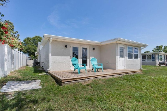 back of house with a lawn, a deck, and french doors