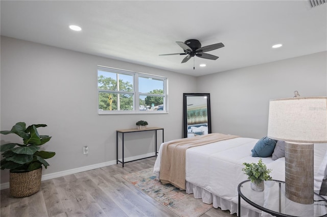 bedroom with ceiling fan and light hardwood / wood-style floors