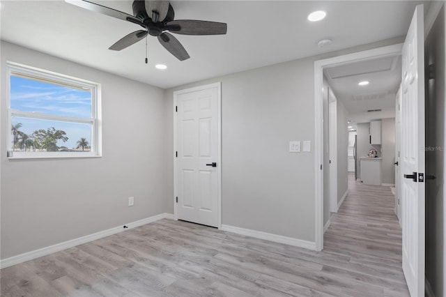 unfurnished bedroom featuring ceiling fan and light wood-type flooring